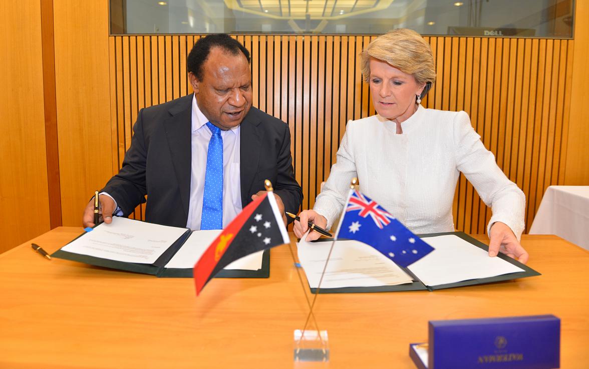 Foreign Minister Julie Bishop and her Papua New Guinean counterpart Rimbink Pato sign the joint communique. Parliament House, Canberra. 11 December 2013.