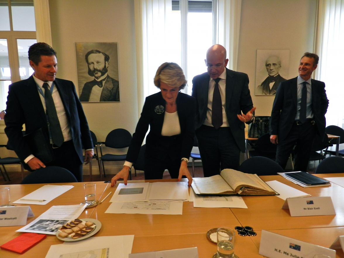 Minister Bishop examines Paul Royle's war records with Yves Daccord, Director General of the International Committee of the Red Cross.