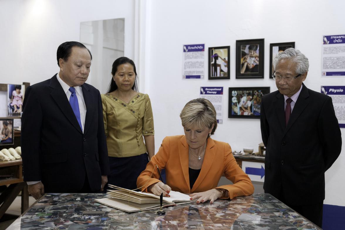 Foreign Minister Julie Bishop signs the guestbook at the UXO Visitor Centre of the Cooperative Orthotic and Prosthetic Enterprise (COPE). Photo: Bart Verweij