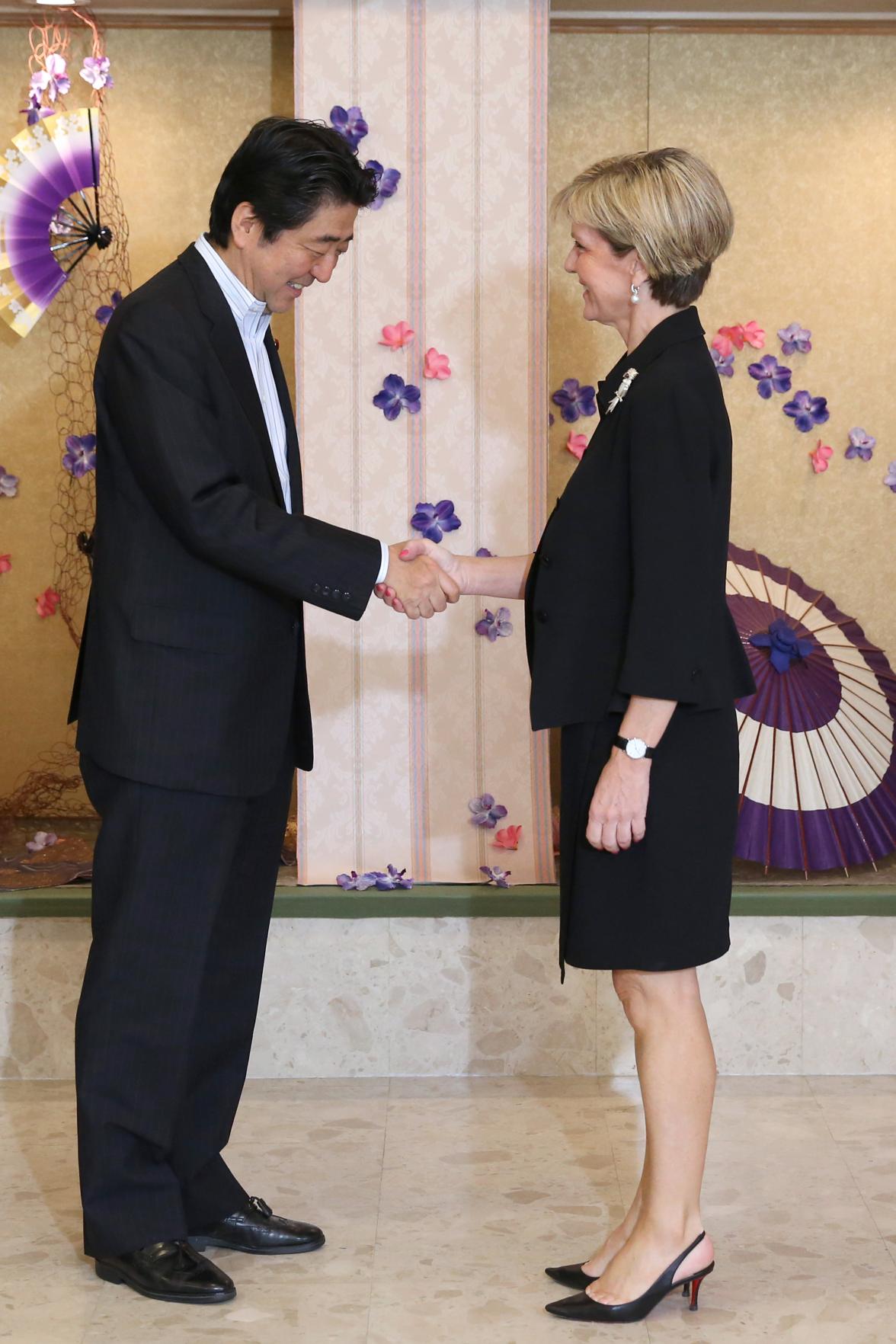 Australian Foreign Minister Julie Bishop is greeted by Japanese Prime Minister Shinzo Abe at the opening of the PALM7 Summit in Iwaki Japan. 23 May 2015.