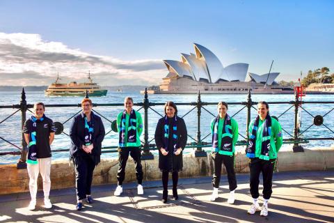 Group photo of attendees following a press conference with the Sydney Harbour and Sydney Opera House in the background.