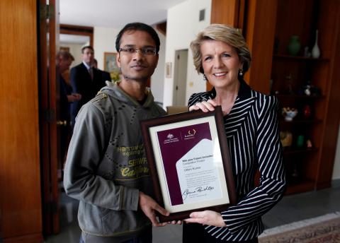 Australian Foreign Minister Julie Bishop presents a certificate to Uttam Kumar  in New Delhi, India, Monday, November 18, 2013. (Photo/Mustafa Quraishi)