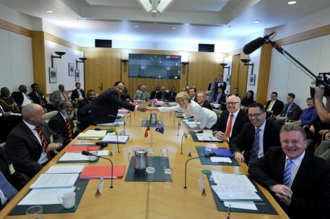 Foreign Minister Julie Bishop shaking hands with PNG Minister for Foreign Affairs and Immigration Rimbink Pato alongside Ministerial colleagues and officials, at the 22nd Papua New Guinea – Australia Ministerial Forum. Parliament House Canberra, 11 Decemb