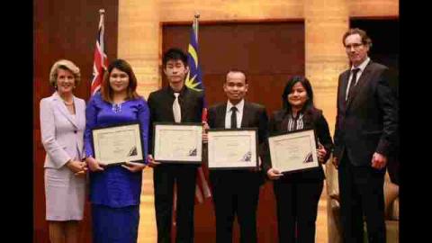 Foreign Minister Bishop presenting the inaugural Australia-Malaysia 'Towards 2020' Scholarships. Recipients include (from left to right): Mrs Nastassia binti Affendi, Mr Lee Siang Hin, Mr Mohd Ridzwan Shahabudin, and Dr Masria binti Mustafa. Hosted by Aus